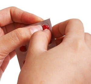 Removing A Pill From Its Packet 