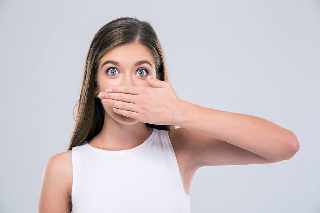 covering her mouth 