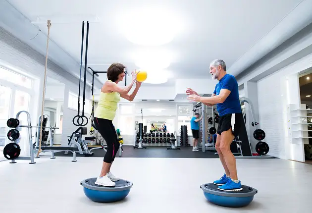 senior couple in gym working out