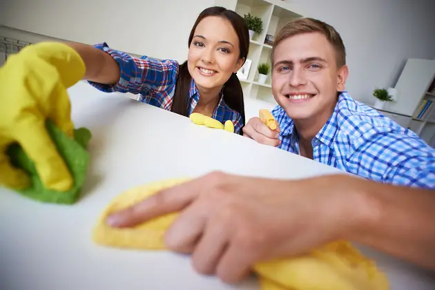 couple dusting at home