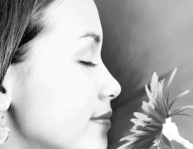 Girl Smelling A Big Flower