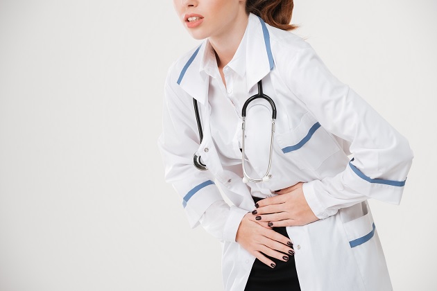 woman doctor suffering from stomach ache