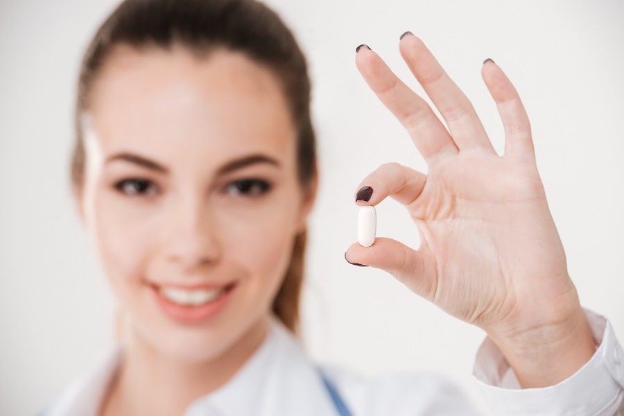 doctor holding pill