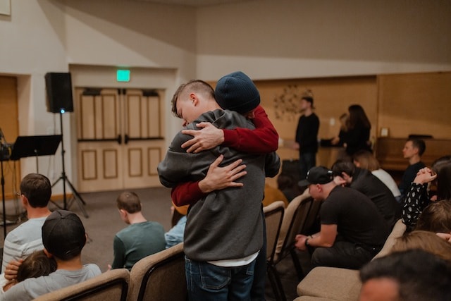 Two people hugging during support group therapy